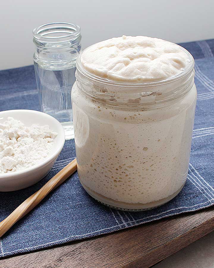 Bubbly wild yeast in a glass jar ready to be used in a gluten-free sourdough loaf. freshisreal.com