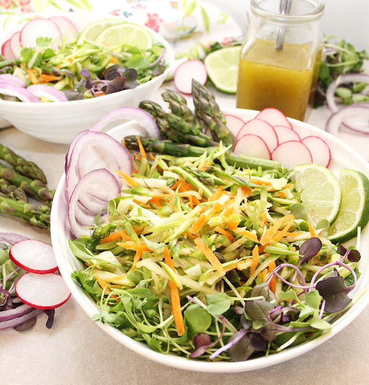 Fresh seasonal asparagus grated and combined with carrots, fresh fennel, cilantro, and apple for an Easy Asparagus Salad. Served with a 5-ingredient dressing made of olive oil, lemon juice, maple syrup, grey sea salt and pepper. Thinly sliced radishes, red onions or chopped green onions, and sprouts make perfect garnishes. Find the recipe at freshisreal.com