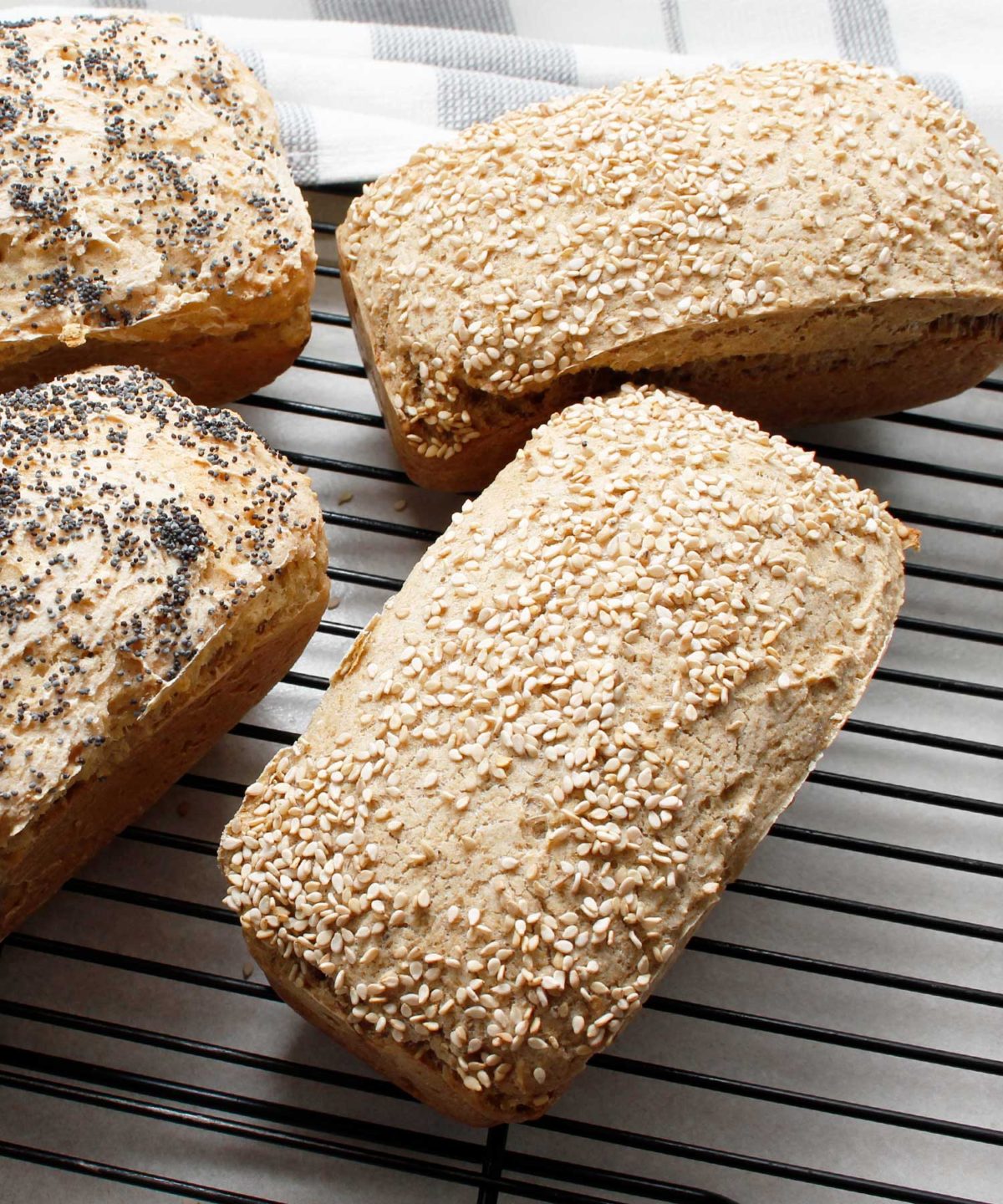 Mini gluten-free vegan loaves cooling on wire rack.