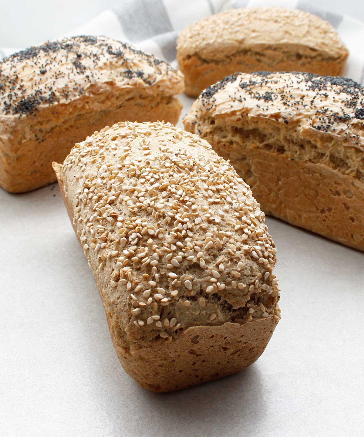 Beautiful mini loaves of yeast-free, gluten-free, vegan bread. Topped with sesame seeds and poppy seeds.