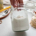 Lively grain-free cassava flour sourdough starter in a clear jar.