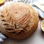 A beautifully scored boule of gluten-free sourdough bread.