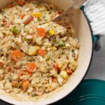Large Dutch oven with beautiful vegetable medley with vegan cream sauce.