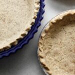 Three pie crust in different types of baking dishes. All prepared with gluten-free vegan ingredients.