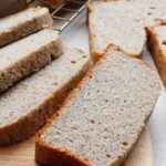 Sliced buckwheat banana bread on a cutting board.