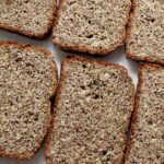 Slices of low-carb flaxseed bread placed on a table to show the texture of the bread.